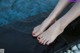 A woman's feet in a pool of water.